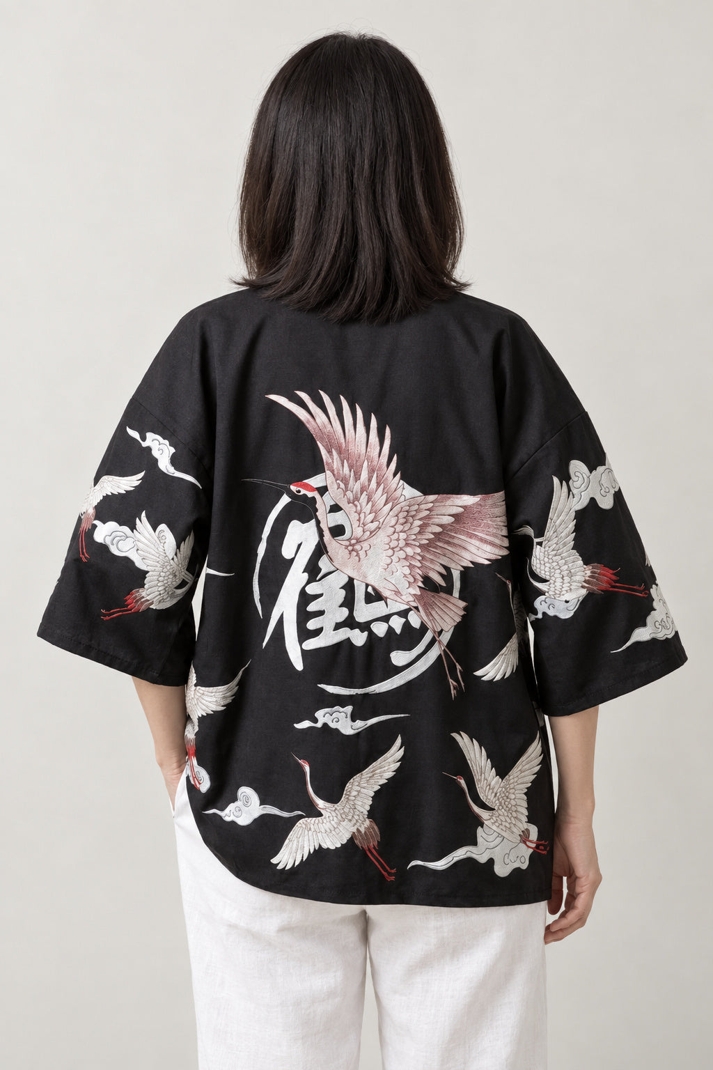 Women's Red Bird Kimono Jacket 'Akane' – back view of black kimono jacket showing the crane and calligraphy crest print