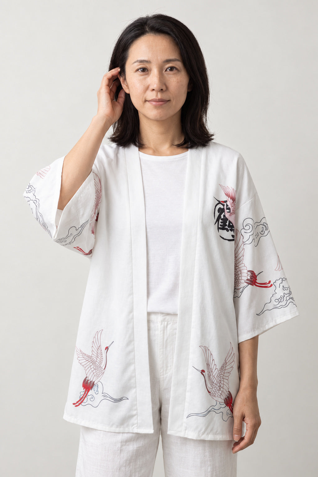 Women's Red Bird Kimono Jacket 'Akane' – white version of the crane kimono jacket with red and pink print, front view on model
