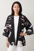 Women's Red Sun Kimono Jacket 'Hatsuhi' – black women's kimono jacket with red sun, cranes and cherry blossom print, Japanese haori style cardigan, front view on model