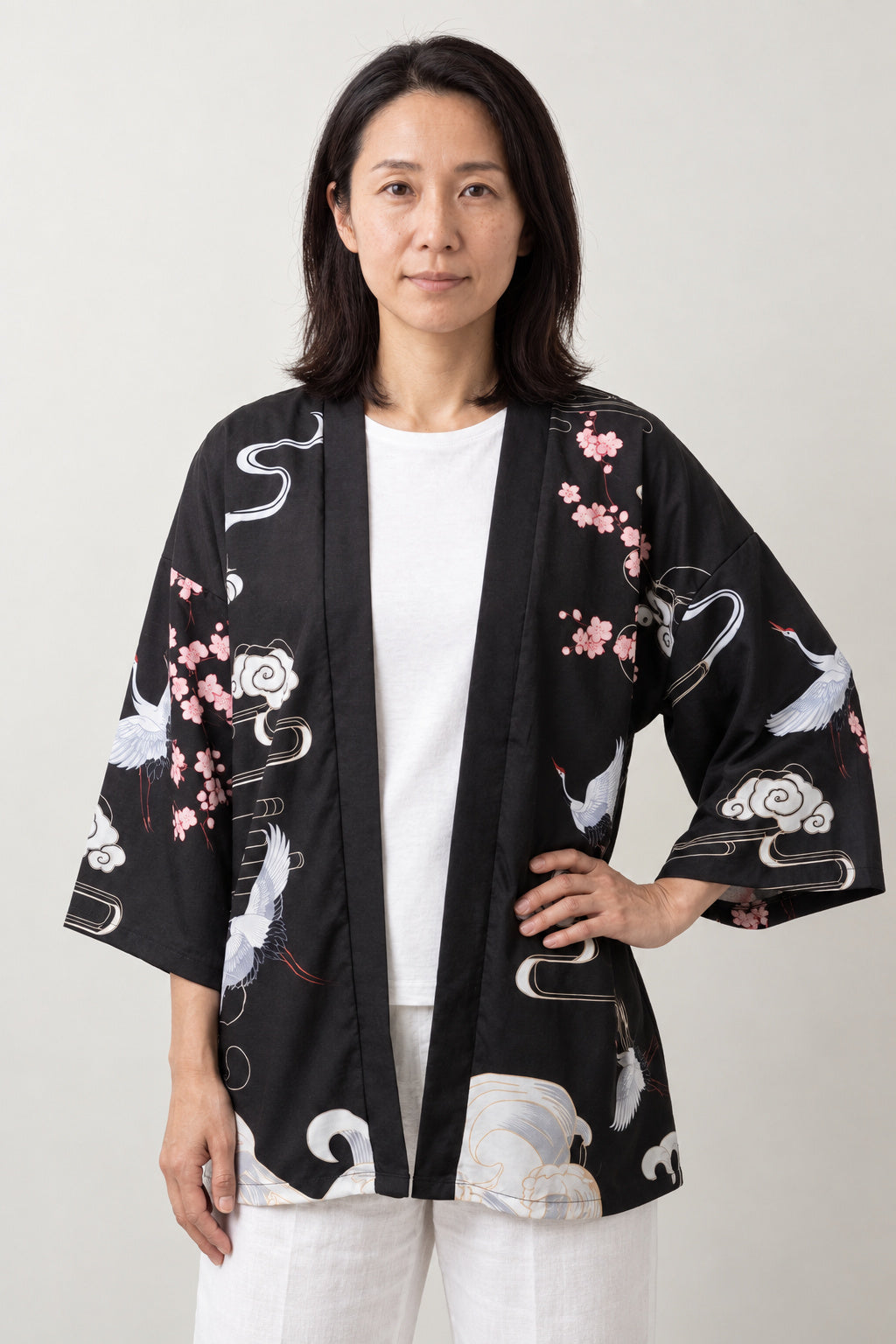 Women's Red Sun Kimono Jacket 'Hatsuhi' – black women's kimono jacket with red sun, cranes and cherry blossom print, Japanese haori style cardigan, front view on model