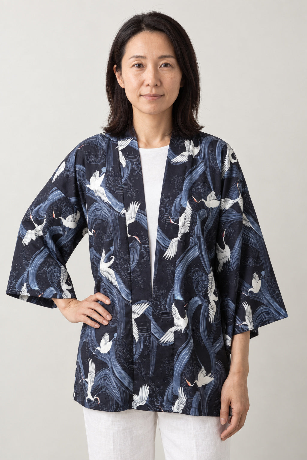 Women's Tonal Navy Kimono Jacket 'Aonami' – navy women's kimono jacket with tonal blue wave and white crane print, Japanese haori style cardigan, front view on model