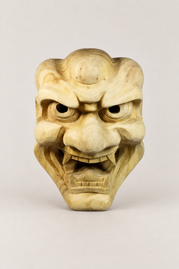 Wooden Japanese Mask 'Ikkoku' – unpainted wooden demon mask with knotted brow, deep eyes and bared teeth, hand carved wooden Japanese mask for the wall, studio view