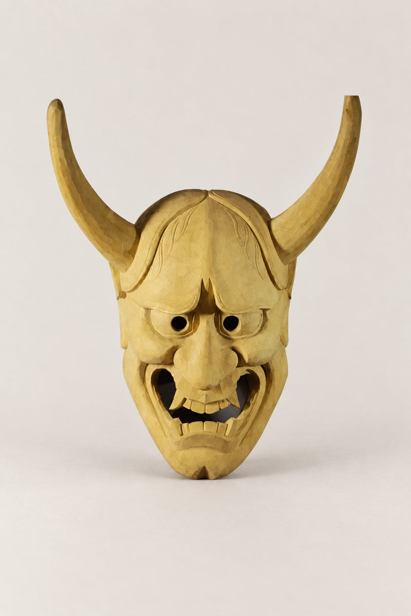 Wooden Oni Mask 'Kiboku' – unpainted wooden oni demon mask with two long horns and bared teeth, hand carved wooden Japanese mask for the wall, studio view