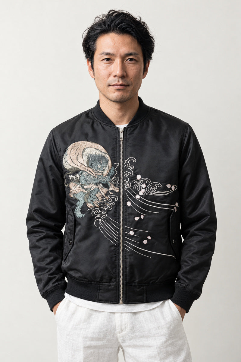 Yokai Crest Bomber Jacket 'Kamon' – black bomber jacket with embroidered dragon crest and blossom, Japanese streetwear, front view on model